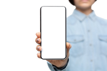 Smartphone with blank screen in hands of unrecognizable woman