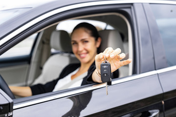 Close up of woman holding keys of her new car