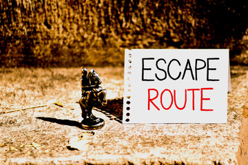 Word writing text Escape Route. Business photo showcasing a route by which a demonstrating may reach a place of safety Bronze Knight Chessman Blank Spiral Notepad Sheet Folded in Half Dry Leaves