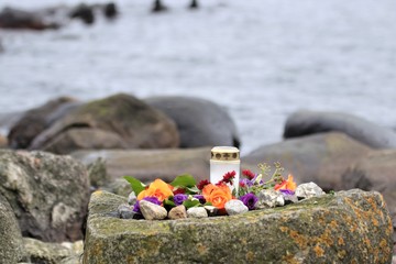 mourning flowers, burial at sea, sympathy message