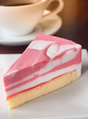Slice of Raspberry Cake or Strawberry Cheese Cake on a White Plate. Chose up of Strawberry Jam and Cheese Layer Cake.