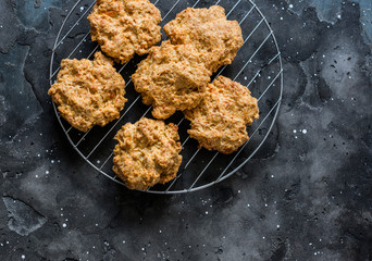 Cheese wholemeal flour biscuits on dark background, top view