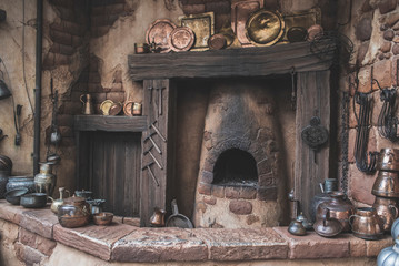 Old Antique Arabian brassware, pots, plates, decorations around a old kitchen with a coal-fired oven/fireplace.