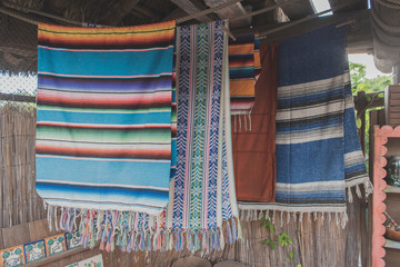 Rugs and carpets hung up on display.