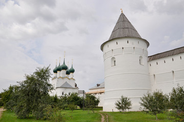 View of the tower of the Rostov Kremlin, the Church of Gregory the theologian and the Metropolitan garden on a summer day. Golden ring of Russia, Rostov Veliky, Russia
