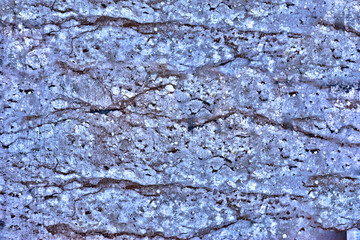 granite wall surface, facade, red-gray with black dots