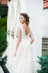Fototapeta premium Beautiful bride with wedding flowers bouquet, attractive woman in wedding dress. Happy newlywed woman. Bride with wedding makeup and hairstyle. Smiling bride. Wedding day. Gorgeous bride. Marriage.