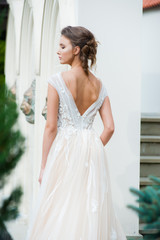 Fototapeta premium Beautiful bride with wedding flowers bouquet, attractive woman in wedding dress. Happy newlywed woman. Bride with wedding makeup and hairstyle. Smiling bride. Wedding day. Gorgeous bride. Marriage.