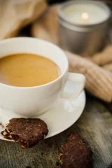 Fotobehang Cup of coffe with milk and chocolate cookies on warm wool blanket © Daria Minaeva