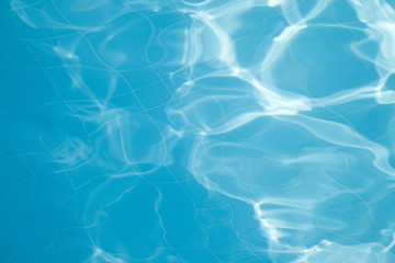 Fototapeta na wymiar A close-up of sun reflections in pool water