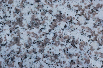 granite wall surface, facade, red-gray with black dots