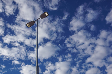 Electricity Lighting Lamp Pole Beside Road with Blue Sky and White Cloud