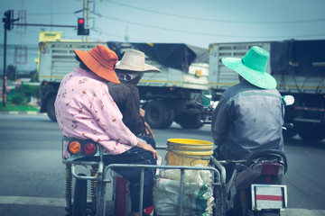 Asian family  parked at red traffic lights by modify motorcycle