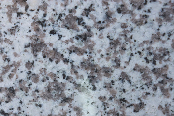 granite wall surface, facade, red-gray with black dots