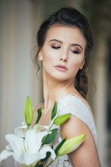 Portrait of bride in wedding dress with wedding bouquet