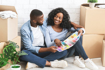 Just married couple choosing walls colour for new apartment