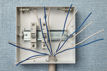 Electrical wires are connected to the switchboard.