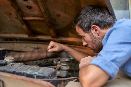Man with old car having a breakdown