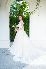 Fototapeta premium Charming Outdoor Bridal Portrait with wedding bouquet