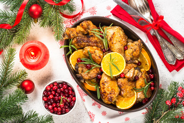 Fototapeta na wymiar Christmas food - roasted chicken with orange on white table.