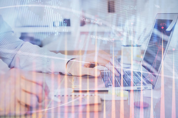 Multi exposure of stock market chart with man working on computer on background. Concept of financial analysis.