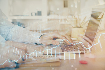 Multi exposure of stock market graph with man working on laptop on background. Concept of financial analysis.