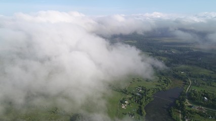 Very slow and smooth flight above the clouds. Slow decrease in height, followed by flying into the cloud.