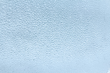 Drops of condensate on the surface of a plastic bottle, close-up