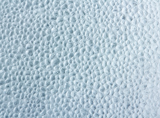 Drops of condensate on the surface of a plastic bottle, close-up