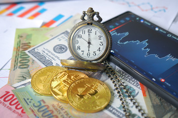 Business and Financial Concept. Multiple Currencies Banknote on graph with classic pocket watch and trading chart