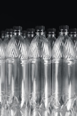 empty plastic bottles on black background