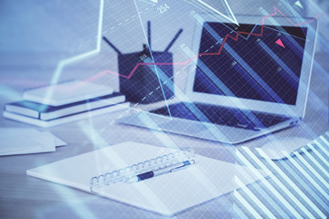 Forex market graph hologram and personal computer on background. Double exposure. Concept of investment.