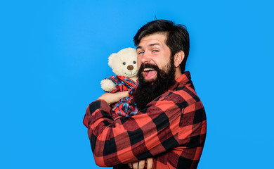 Teddy bear present. Male with teddy bear. Gift and present concept. Bearded man hugging teddy bear. Bearded man with plush toy. Fashion and style. Birthday or anniversary and holiday celebration.