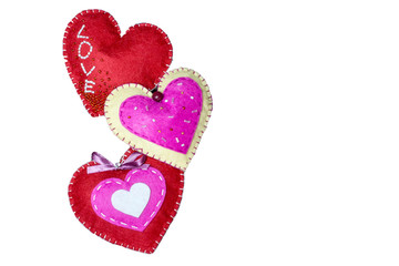 Three hearts with felt with the inscription love on a white background.