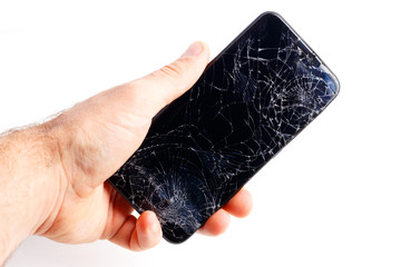 Hand holds a broken smartphone on a white background