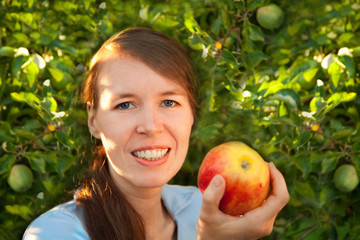 Mädchen mit Apfel vor Apfelbaum