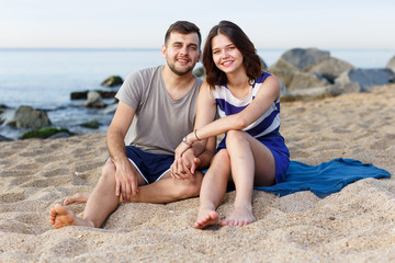 Fototapeta premium Happy loving couple sitting and hugging