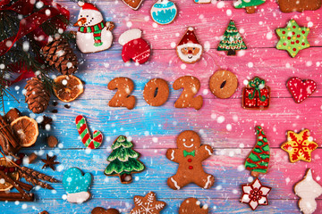 Gingerbreads for new 2020 year on wooden background, xmas theme