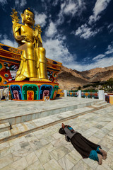 Tibetan Buddhist woman worshiping Buddha, Ladakh