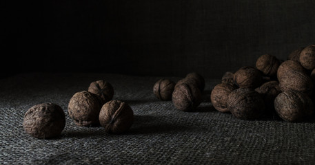still life of walnuts on dark background