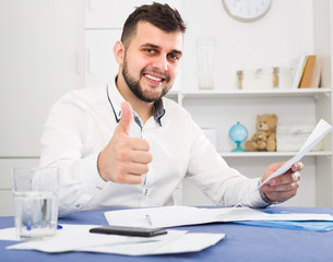 Young male is signing agreement papers