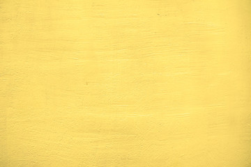Texture of a plastered yellow wall.