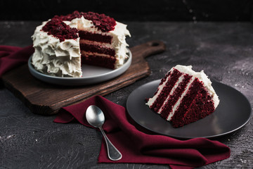 Red velvet cake on dark background, close-up side view. Sweet dessert for the holiday.
