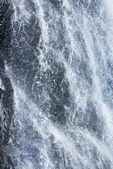 AbstAbstract background of splashes, jets, drops of a waterfall close up