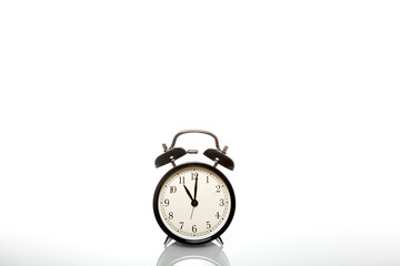 black vintage alarm clock time 11 hours isolated on white background