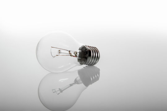Energy saving and incandescent light bulb lies on gray background