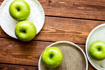 fresh organic green fruits with apples on wooden background top view