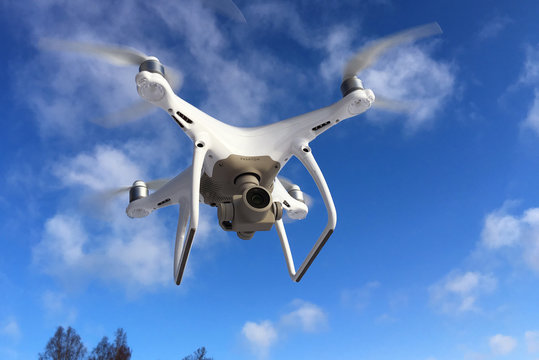 Sodertalje, Sweden - February 4, 2018: One white DJI Phantom 4 Pro drone in flight.