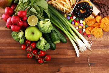 healthy or unhealthy food. Concept photo of healthy and unhealthy food. Fruits and vegetables vs donuts and fast food