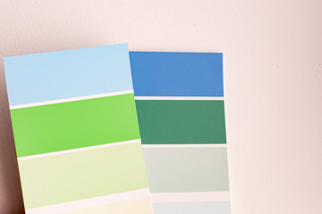 Color palette with various samples. Light background. Paint selection cards, close-up.
